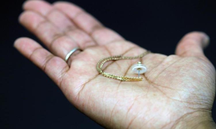 <p>An earring is shown paired with a transdermal patch backing. The white ring is the patch containing the contraceptive hormone. (Credit: Mark Prausnitz, Georgia Tech)</p>