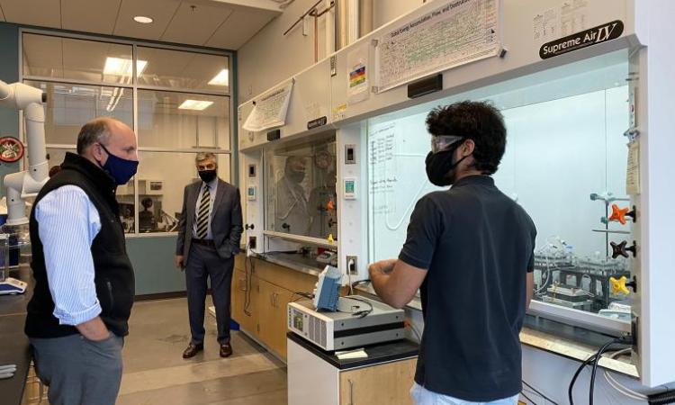 <p>Ph.D. student Aravindh Rajan explains how the world’s first continuous thermoelectrochemical cooler prototype works as Paul M. Dabbar tours the Scalable Thermal Energy Engineering Lab (STEEL). The lab is located within the Carbon Neutral Energy Solutions (CNES) building and is under the direction of Associate Professor Shannon Yee. Photo by Ashley Ritchie</p>