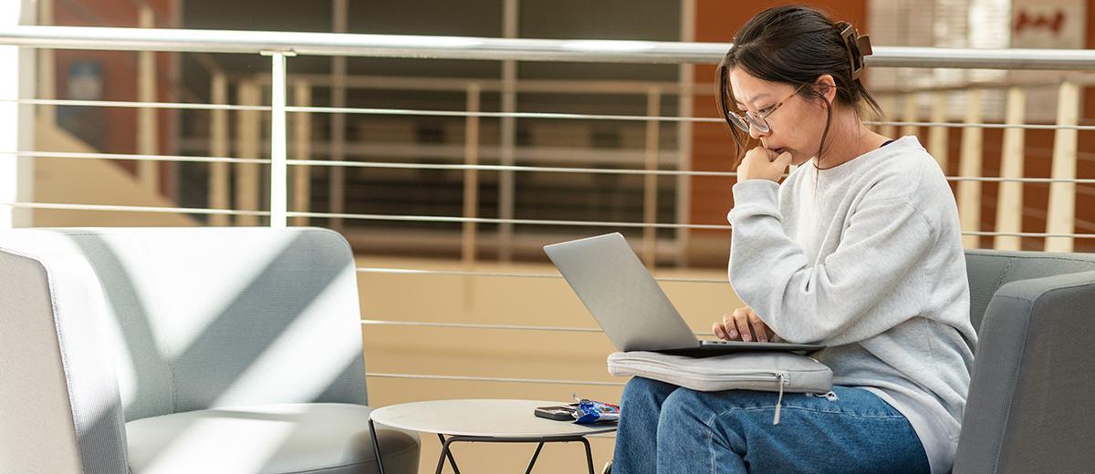 undergrad student studying in atrium